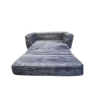 A plush futon in a folded-out, mattress-like position